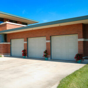 Triple garage doors in a brick home